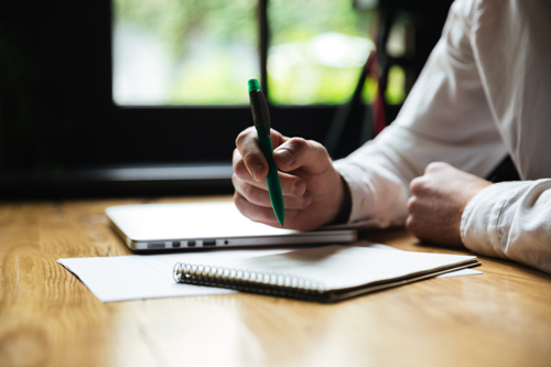 Person With Expat Health Insurance Creating Checklist for Move Abroad