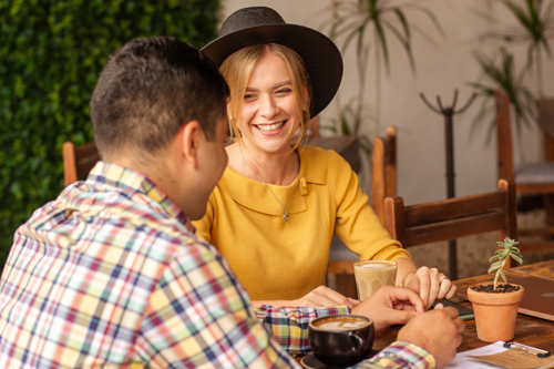 Spouse Talking About Expat Health Insurance over Coffee